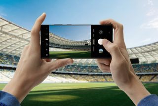 Someone taking a photo of a football stadium using the S23 Ultra
