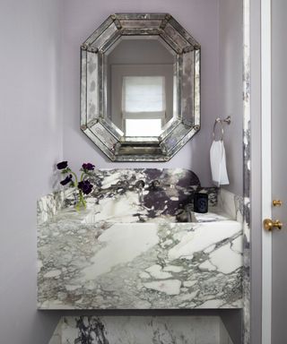 powder room with marble backsplash and vanity