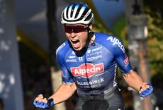 Bike rider called Jasper Philipsen competes in a blue jersey in a bike race