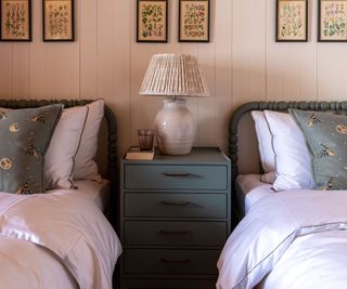 twin bedroom with botanical prints in Swiss chalet by Sims Hilditch