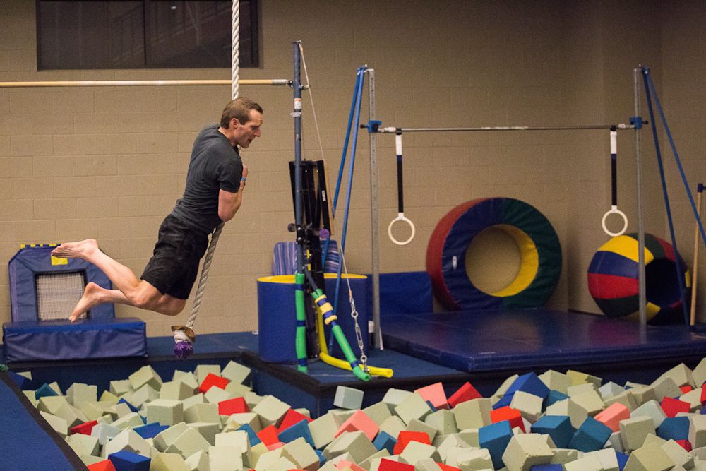 Brad Huff swings toward a landing in the foam pool