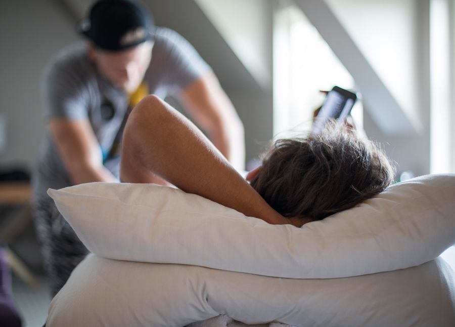 Rick Zabel checks his phone mid-massage