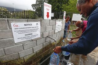 Residents of Cape Town collect drinking water from a mountain spring collection point on Jan. 19, 2018.