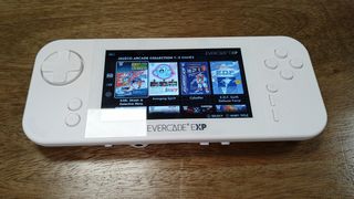 Evercade EXP review; a white handheld games console on a wooden table