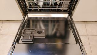 Open dishwasher door showing bottom rack