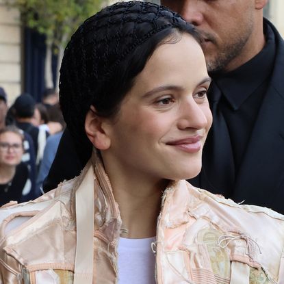 Rosalia in Paris wearing a strappy coat