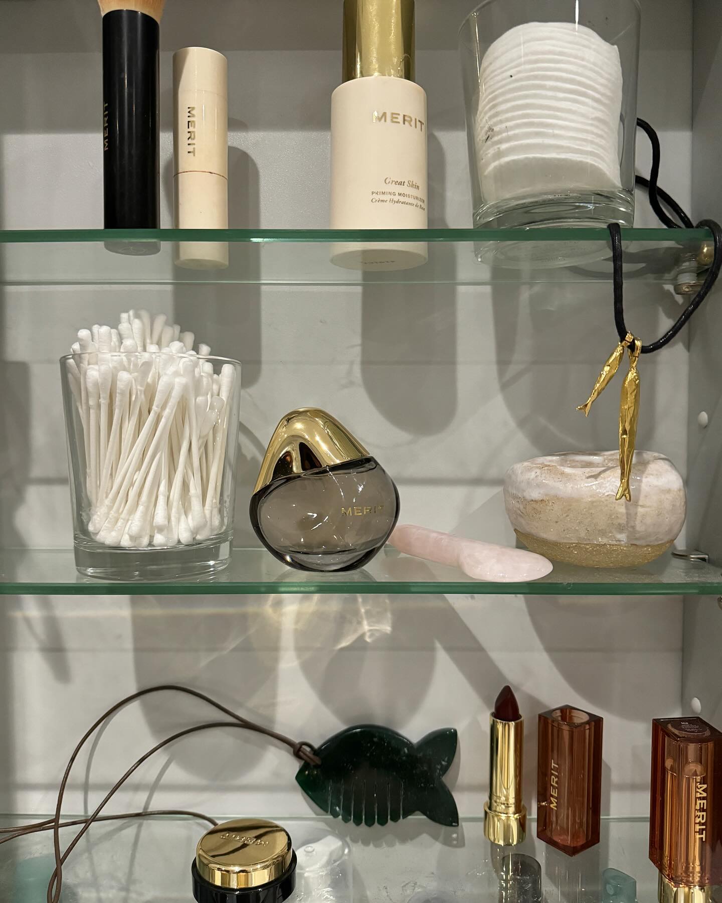 An image of Merit Retrospect, one of the most popular perfumes 2025, on a bathroom cabinet shelf