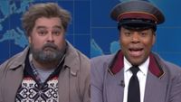 From left to right: Bobby Moynihan as Drunk Uncle and Kenan Thompson dressed as a doorman. Both are on Weekend Update on SNL.