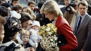 32 of the best Princess Diana Quotes - Diana recieving flowers from a crowd at a community centre in Brixton