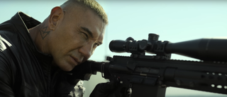 Dave Bautista taking aim with a sniper rifle in The Killer's Game