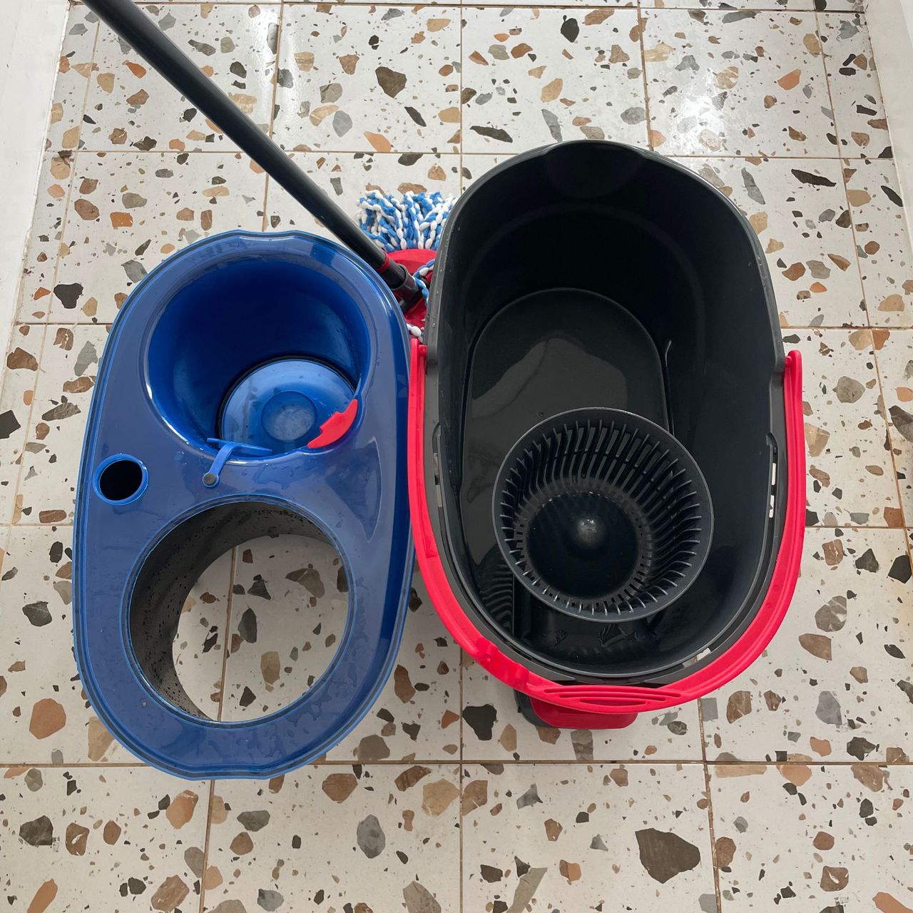 Vileda RinseClean Spin Mop &amp; Bucket System separated into compartments on terrazzo tiled floor