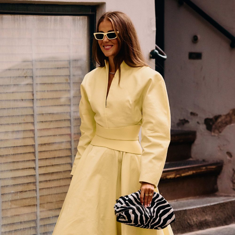 Copenhagen Fashion Week attendee wears a zebra print bag and shoes.