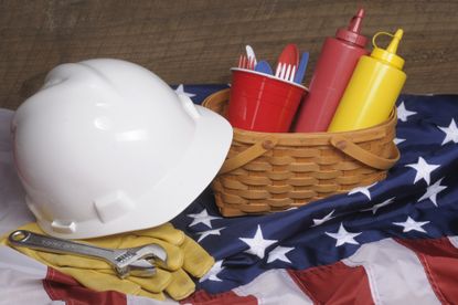 white hard hat next to basket of condiments on american flag