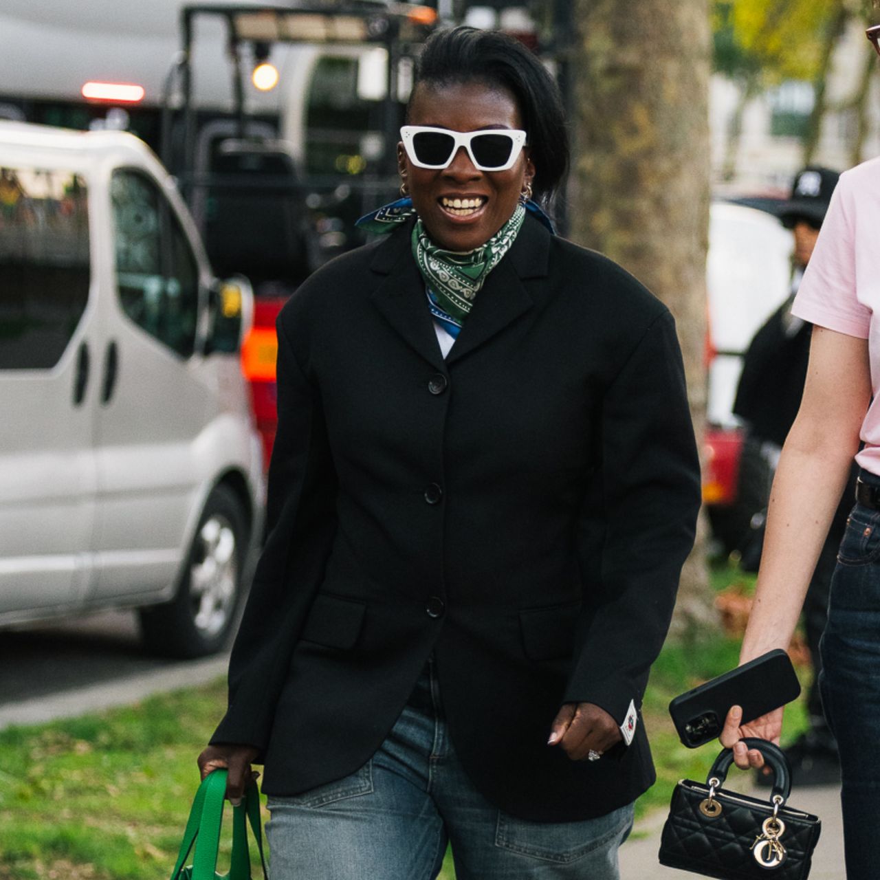 nikki ogunnaike wearing a jacket, and a scarf, and jeans 