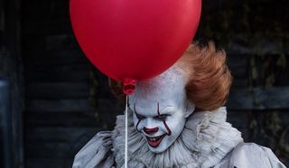 IT Bill Skarsgard smiling with a balloon in hand