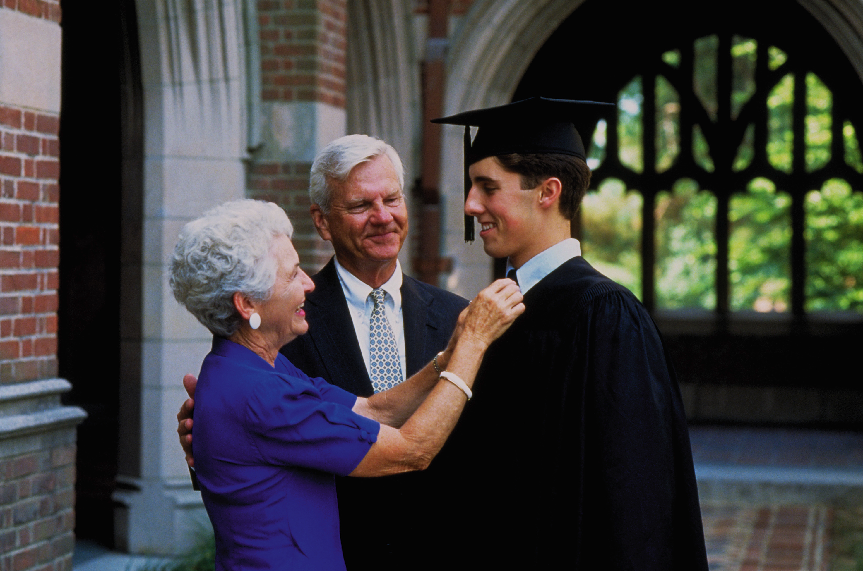 Grandparents with grandson graduating college