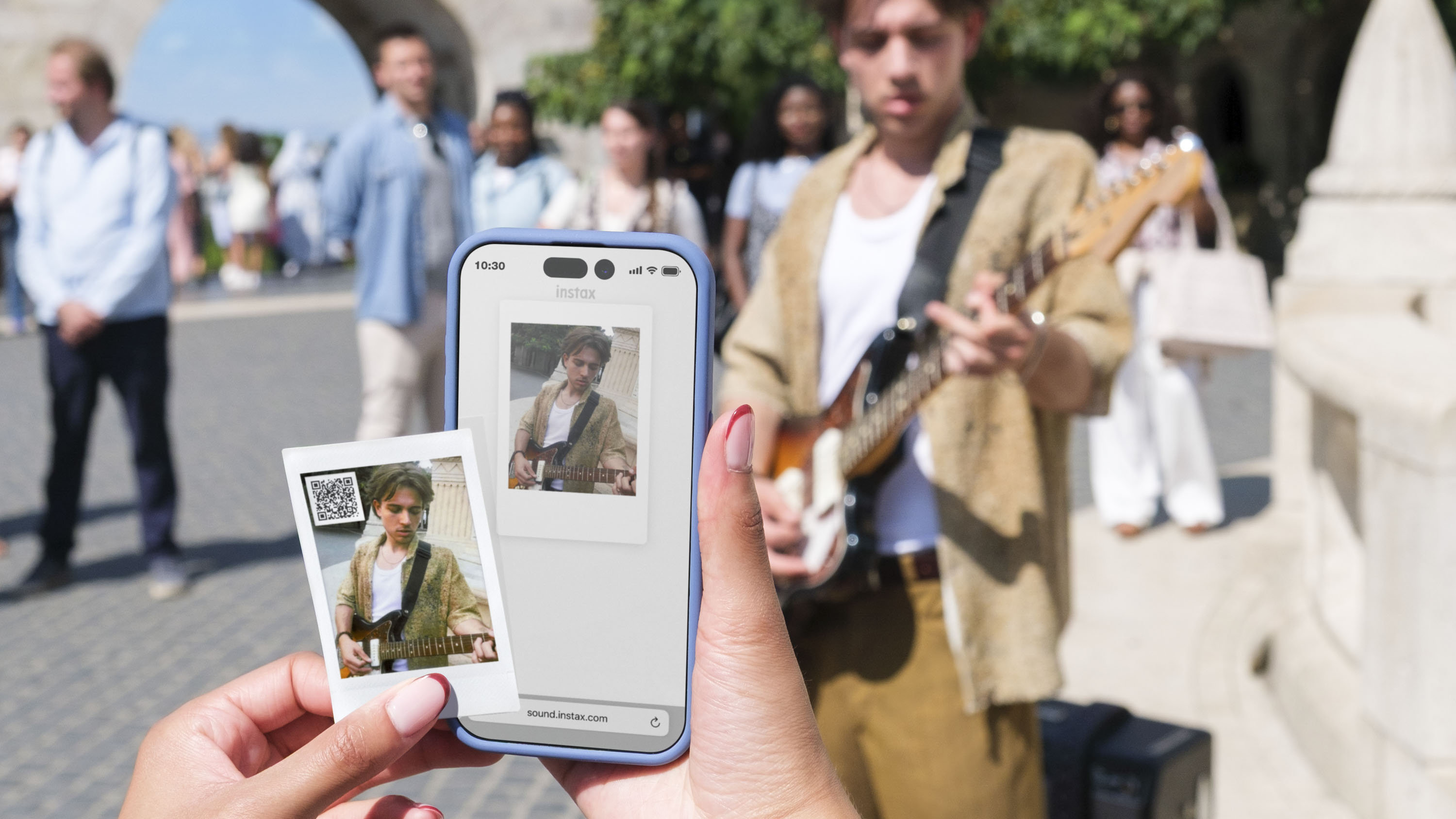 Fujifilm Instax mini LiPlay+ hybrid instant camera app with a print of what's on screen held in front of it