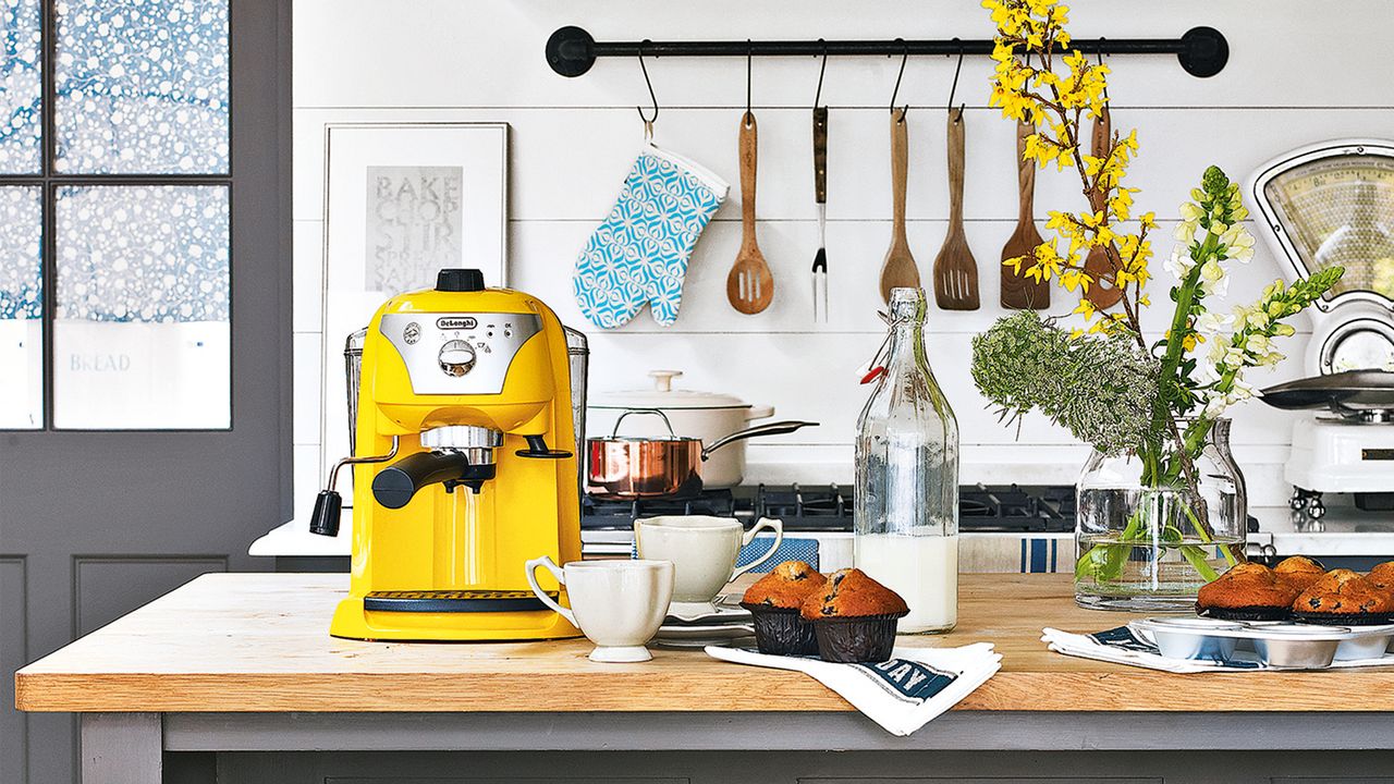 Kitchen island with coffee machine and mugs set up ready for serving