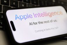 closeup of Apple Intelligence website displayed on smartphone with laptop keyboard in background