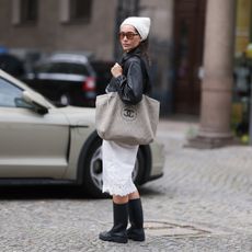 woman wearing black knee high boots