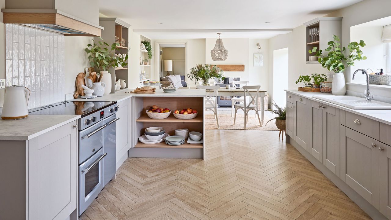 Open-plan kitchen in a barn conversion leading to dining area with white dining table and chairs