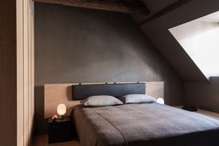 Charcoal walls in a bedroom with matching bedding