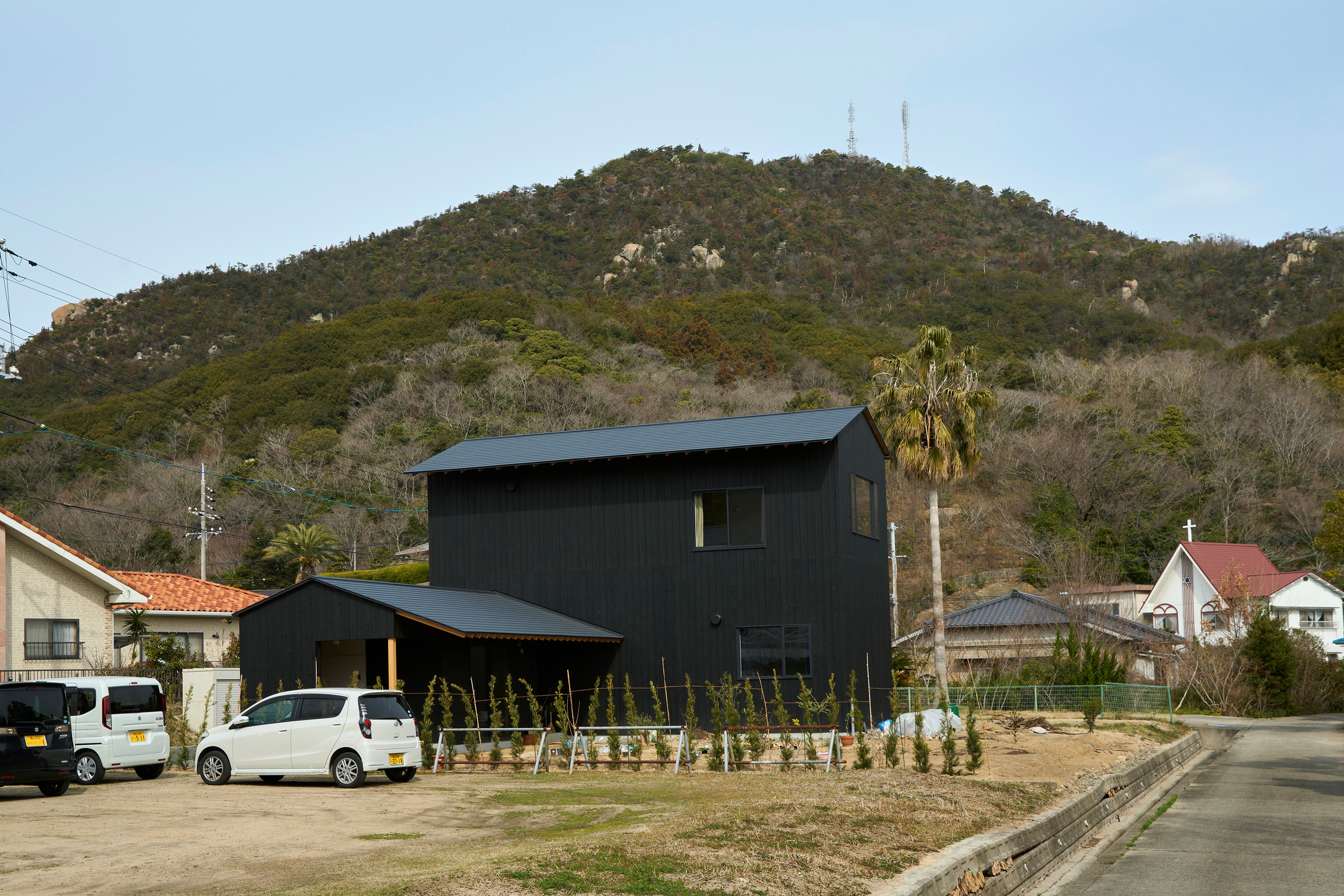 From the street, the house offers a blank, mysterious facade
