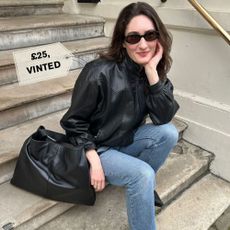 Natalie wears a pre-loved leather bomber jacket.