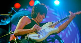 Jeff Beck leans into a solo on his Olympic White Fender Stratocaster, without pick as per his preferred style