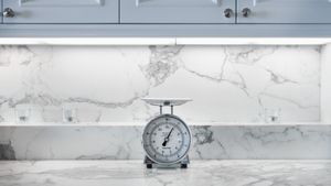 a marble countertop in a kitchen with weighing scales