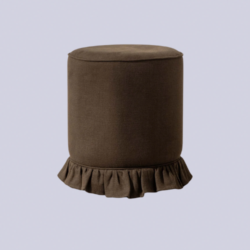 A brown fringed ottoman