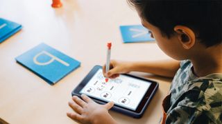 A child draws with the Logitech Crayon stylus. 