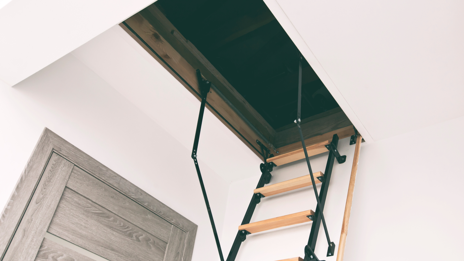An open loft hatch with an integrated loft ladder