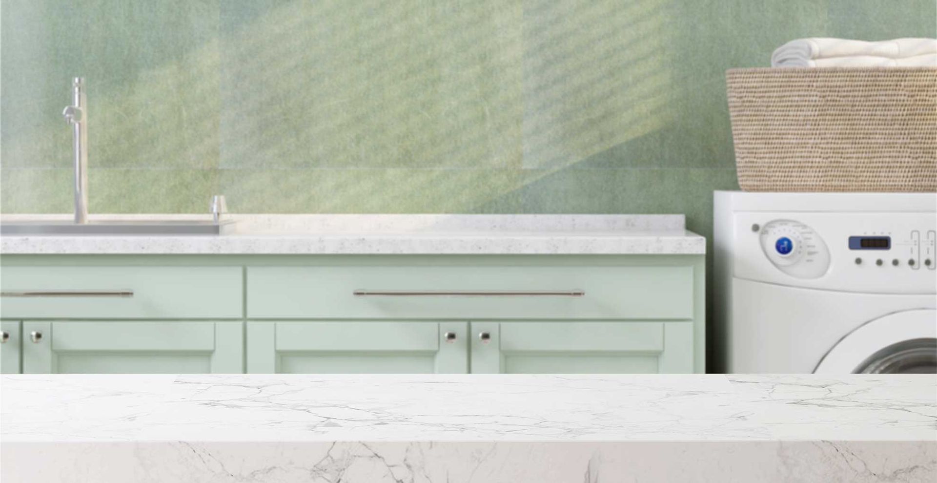 sage green laundry room with white marble counters to create a dedicated folding area as a simple laundry room organization idea