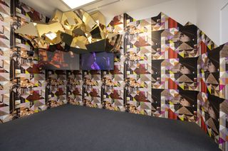 sonia boyce artwork, images on a wall and two screen with films showing, gold decorative wall piece above