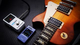 TC Electronic Polytune next to a Gibson Les Paul 