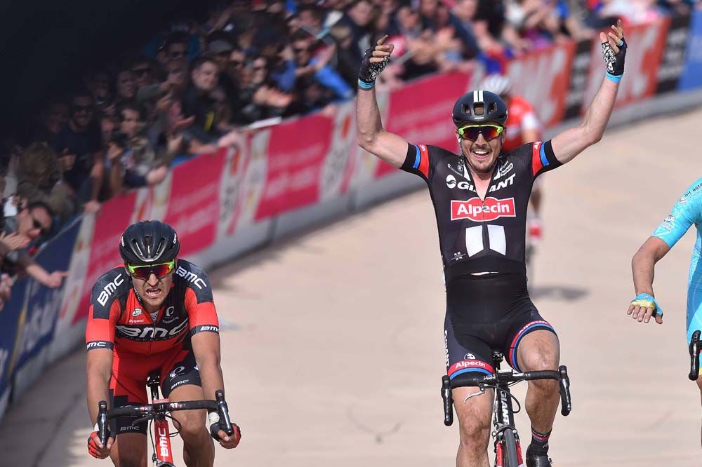 John Degenkolb (Giant-Alpecin) celebrates as the other riders suffer in defeat