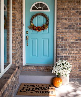 autumnal door with wreath and pumpkin