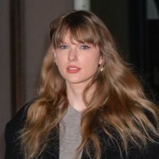 Taylor Swift on January 18, 2024 in New York City wearing a gray sweater and black overcoat