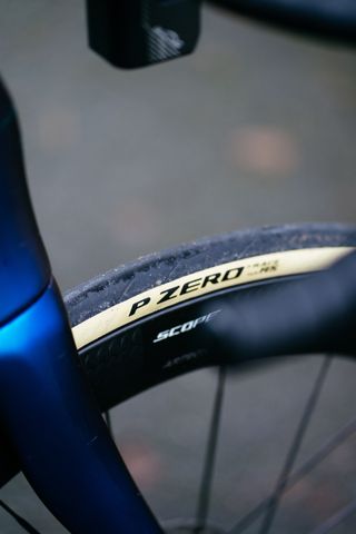 A close up of a tan wall Pirelli P Zero Race TLR RS tyre as viewed from the handlebars