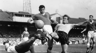 30th August 1958: Wolverhampton Wanderers centre forward, Jackie Henderson, competes for the ball in the opposition goal area with Chelsea defender, Peter Sillett, and reserve goalkeeper, Robertson, at Stamford Bridge. (Photo by Edward Miller/Keystone/Getty Images)