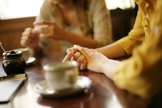 Women sitting at a table with coffee