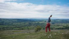Beautiful woman holding her arms in the air, Black Mountains, Powys, Snowdonia, Wales, UK.