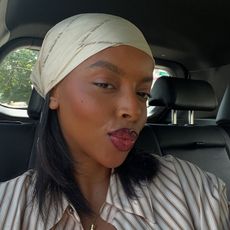 Creator @aysha.sow taking a car selfie with glossy lips