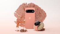 A pink and gold Google Pixel 11 Pro on a white/pink gradiant background with a piece of coral