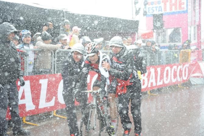 Cadel Evans (BMC) is helped after the finish