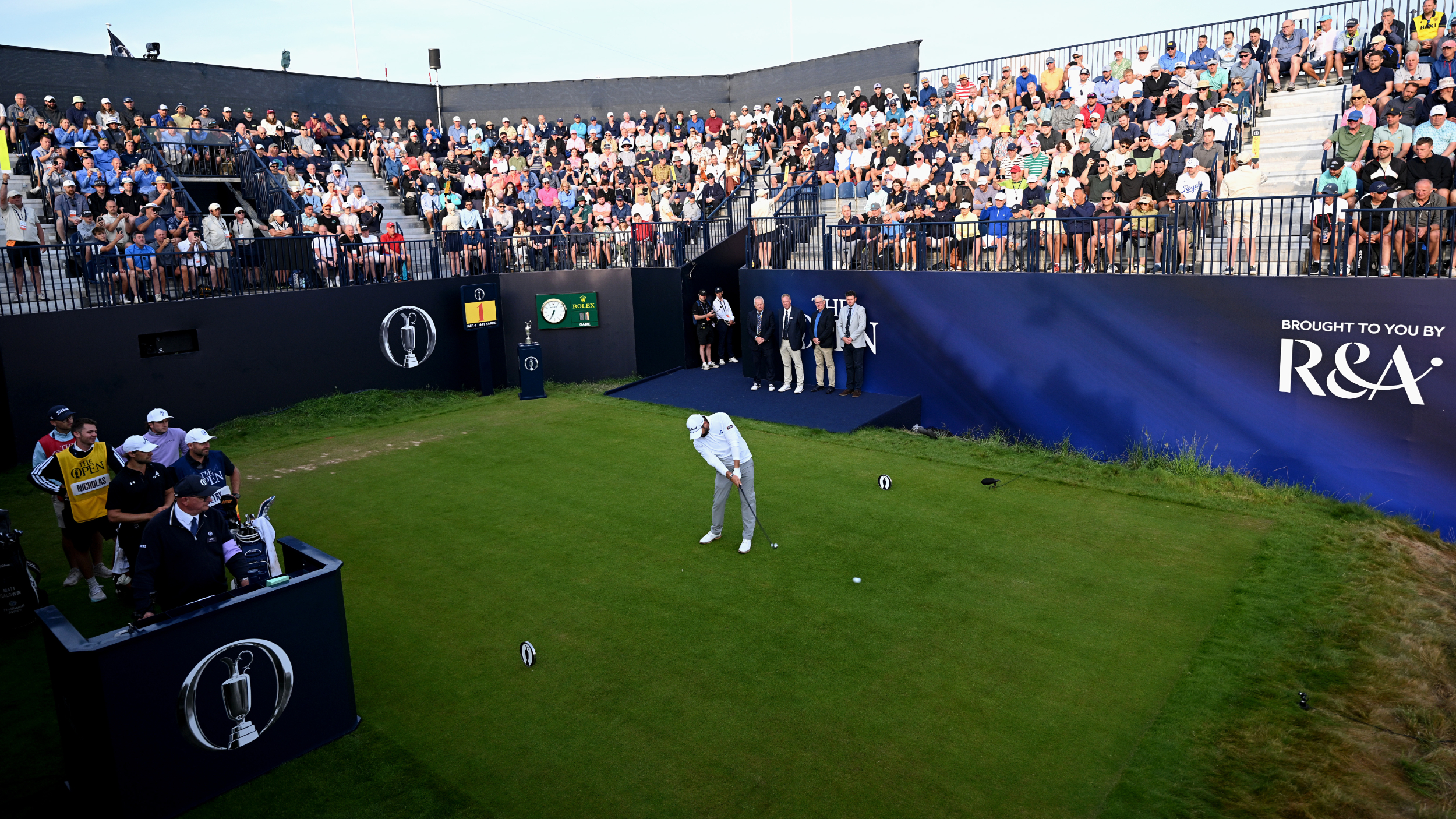 Matthew Baldwin plays the first tee shot at The Open 