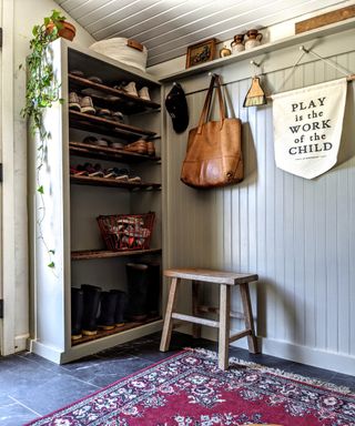 Vintage inspired mudroom with wall panels, open shelving, wall hooks, picture rail, stool and book case for storage - Shauna Speet