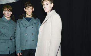 Three male models posing in jackets