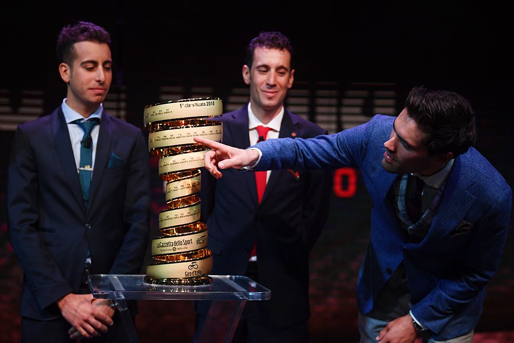 Defending champion Tom Dumoulin points to his name on the Giro d'Italia trophy